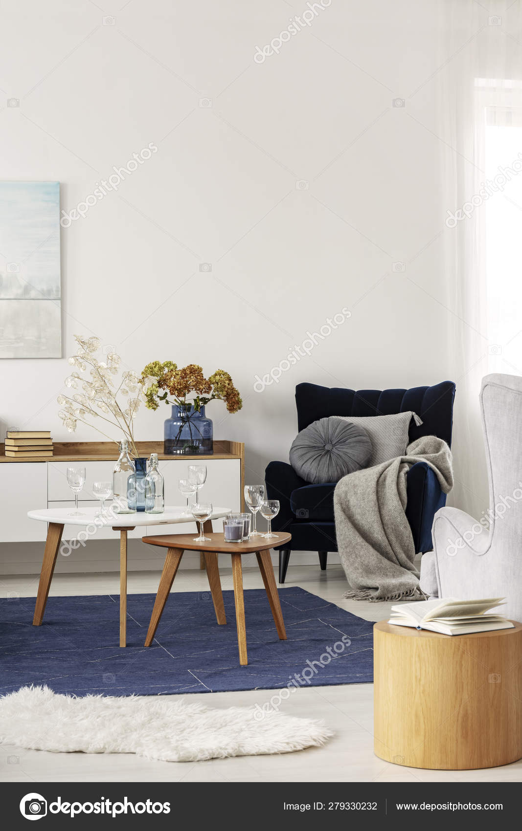Grey and navy blue living room interior with coffee tables and velvet