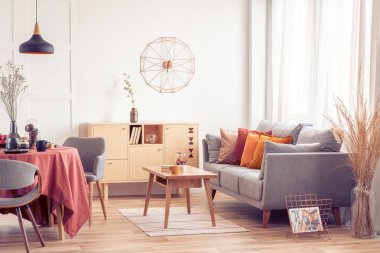 Açık alan yemek ve gri İskandinav kanepe ve sandalye ile masa ile yaşam alanı