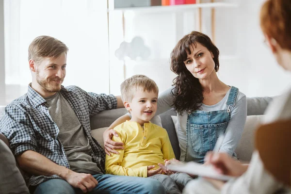 Caring parents and misbehaving boy during therapy session with counselor — Stock Photo, Image