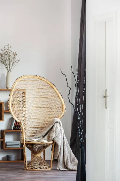 Cadeira de pavão de vime com cobertor no interior do quarto confortável com design escandinavo — Fotografia de Stock