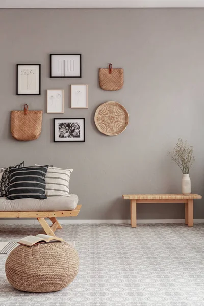 Gallery of black and white posters and wicker accessories on beige wall of Scandinavian living room — Stock Photo, Image