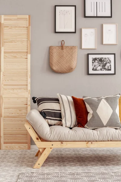 Patterned pillows on comfortable scandinavian couch in beige natural interior — Stock Photo, Image