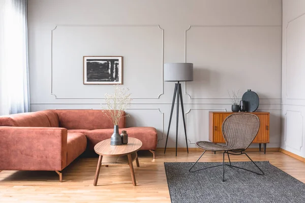 Stylowa wysoka szara lampa w eleganckim salonie z wygodną, brązową kanapą narożną — Zdjęcie stockowe