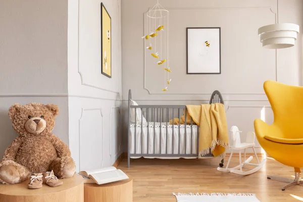 Posters on the walls of chic baby bedroom with grey and yellow design — Stock Photo, Image