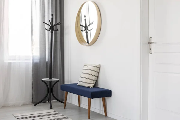 Round mirror in wooden frame on empty white wall of bright living room interior — Stock Photo, Image