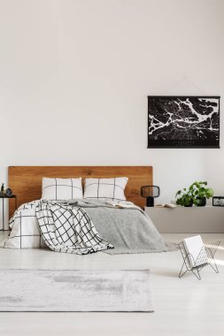 Ahşap headboard ile kral boy yatak ile modern yatak odasında siyah harita ile beyaz duvar üzerinde kopya alanı