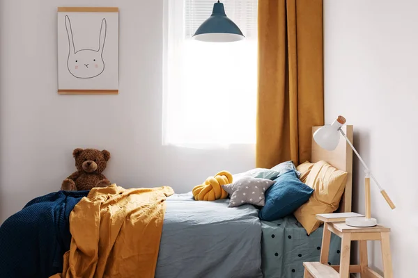 Stylish blue and orange kid's bedroom design in bright apartment — Stock Photo, Image