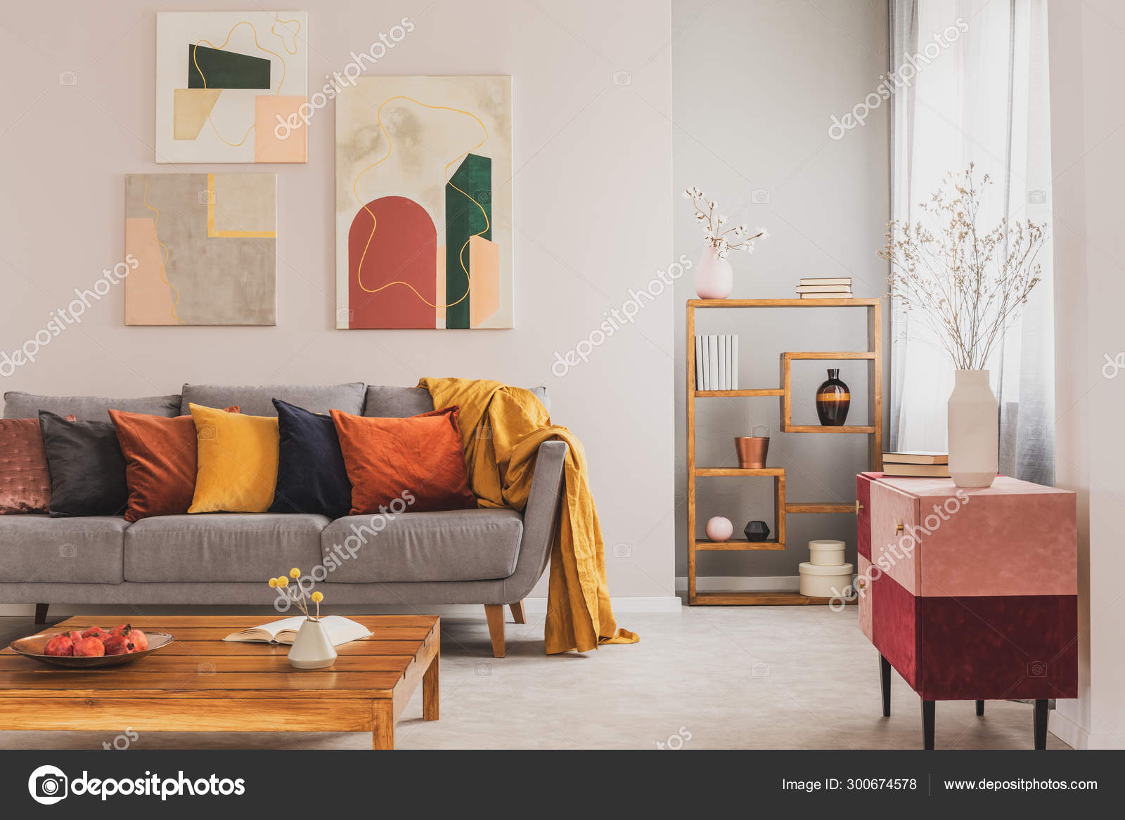 grey couch with orange pillows