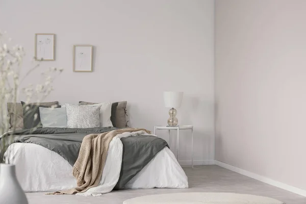 밝은 침실 내부에 편안한 침대에 회색 이불에 흰색과 베이지 색 담요 — 스톡 사진