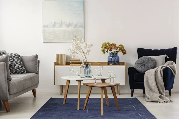 Elegant white, grey and blue living room interior with scandinavian sofa and velvet armchair — Stock Photo, Image