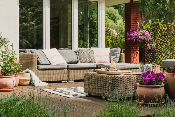 Classy furniture on wooden terrace in green beautiful garden — Stock Photo, Image