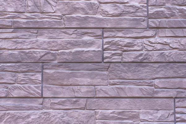 Kahverengi renkli bir evin ön cephesini tamamlamak için dekoratif taşın dokusu