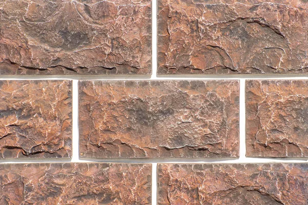 Koyu kahverengi tonlu bir evin ön cephesini tamamlamak için dekoratif tuğlaların dokusu