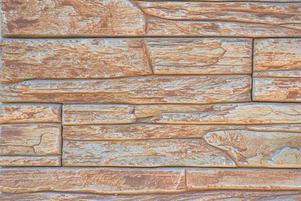 Bej tonlu bir evin ön cephesini tamamlamak için dekoratif taşın dokusu