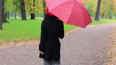 Kırmızı bereli kadın şemsiyeyle yağmurun altına girsin