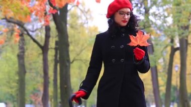 Kırmızı akçaağaç yaprağı olan güzel bir kadın. öğretmenler günü