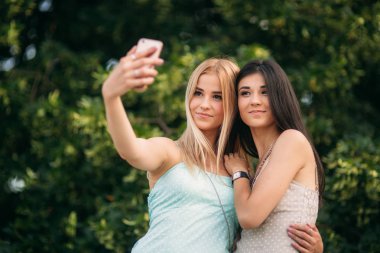 Esmer ve sarışın fotoğraflandı ve hayatın tadını çıkarın. Güneşli bir gün. Yaz