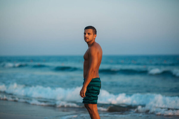 Portrait of an attractive young man on a tropical beach