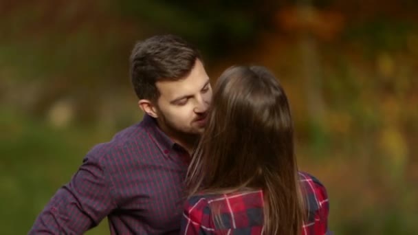Husbband kisses his wife in autumn day.slow motion — Stock Video