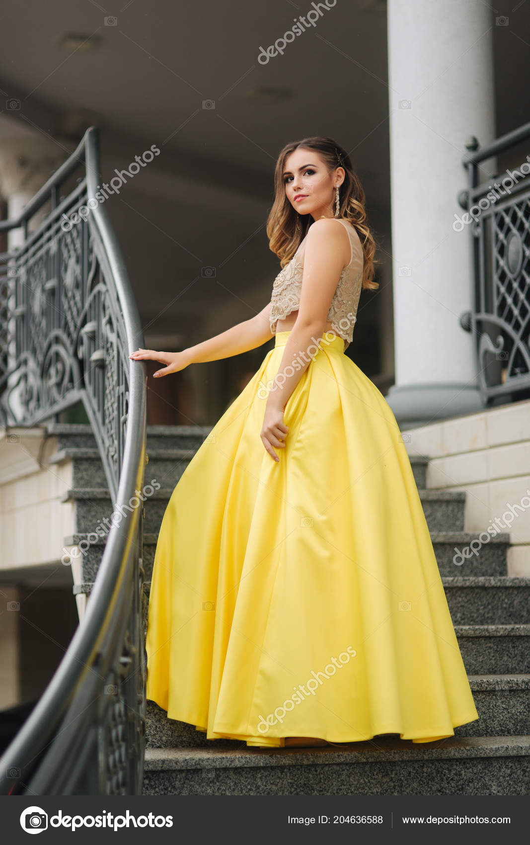 Beautiful Girl With Makeup And Hairstyle Is Standing On The Steps