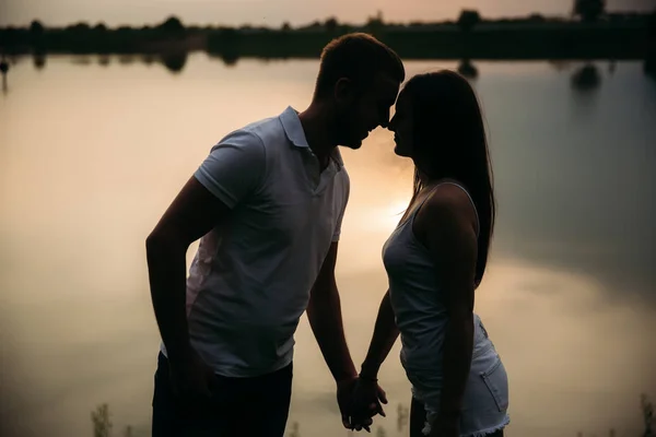 Silhouette de beau couple. lac en arrière-plan — Photo