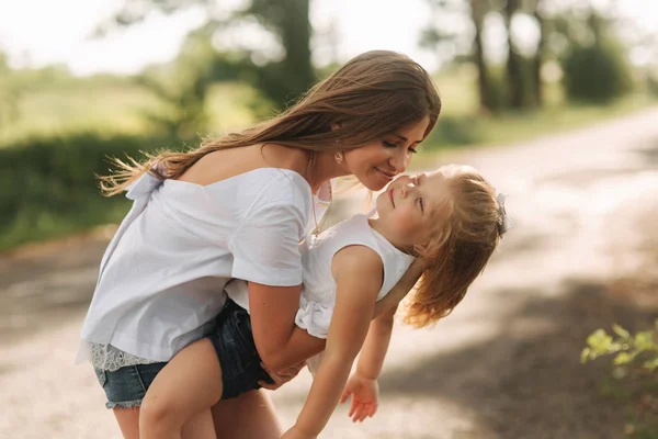 Liten flicka ger hennes mamma en kyss — Stockfoto