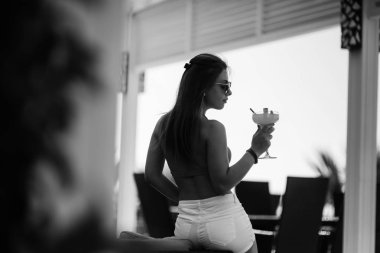 Kokteyl ile kadın silüeti. Yaz saati.