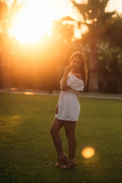 Lady in witte jurk in de buurt van de palm tijdens de zomermaanden — Stockfoto