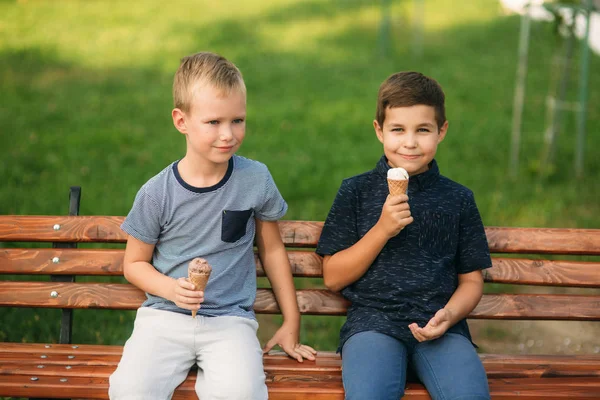 Gyermek ült a padon, és evés fagyit — Stock Fotó