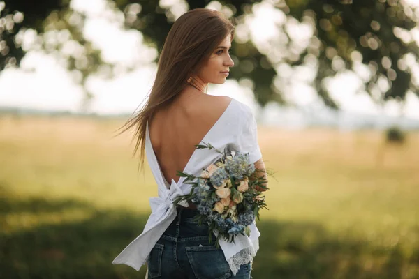 Beautiful mother have flower bouquet and have a good time near the nature