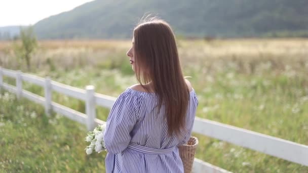 Attraktive Schwangere posiert vor der Kamera und lächelt. Frau stehen in der Natur und gehen Gedankenfeld in der Nähe des Hofes. Zeitlupe — Stockvideo