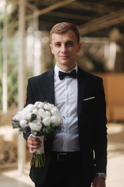 Genç groon düğünü gelini için bir buket çiçek al