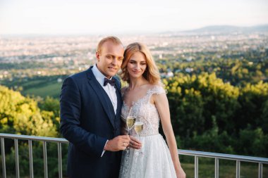 Evlilik çift şehir ve İçecek şampanya bardağı üzerinden arka plan üzerinde durmak