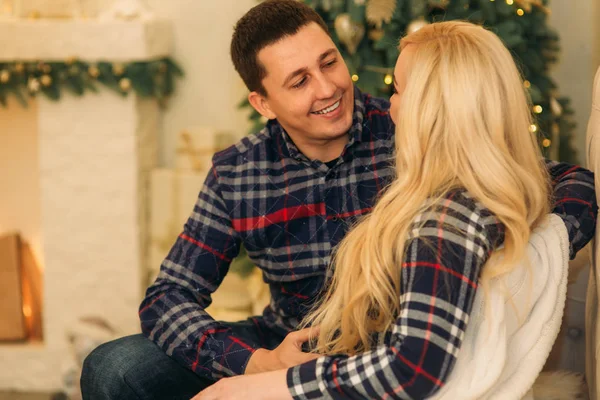 Casal feliz em espírito de férias mostrando afeto um pelo outro. Vestido com roupas xadrez. Mulher grávida gentil — Fotografia de Stock