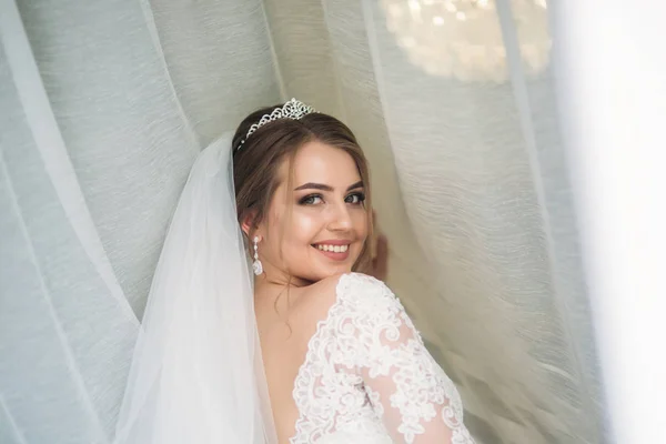 Portrait of a bride in a wedding dress. The bride dresses in the hotel — Stock Photo, Image