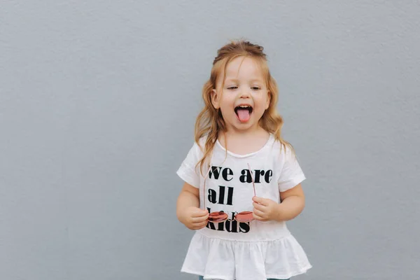 Little girldressed in white shirt with text, we are all kids — Stock Photo, Image