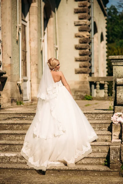 Fantastic bride walk near the palace. Wedding dress