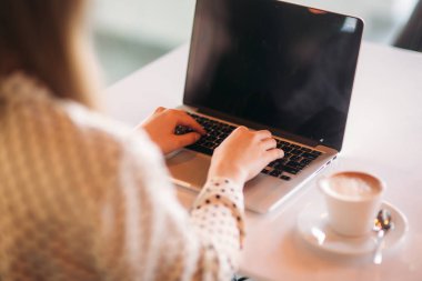 İş kadını dizüstü bilgisayar ve telefon Cafe