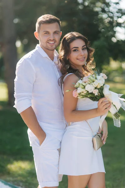 Portrét krásné páru v bílých šatech. Pohledný muž a elegantní dáma. Brilantní úsměv — Stock fotografie