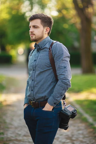 Portrait of handome photographer outside. Man use strap for professional camra. Expensive lens — Stock Photo, Image