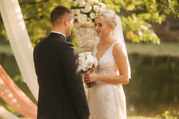 Matrimonio coppia sulla cerimonia al di fuori. bella sposa e bello sposo. Appena sposata. — Foto Stock