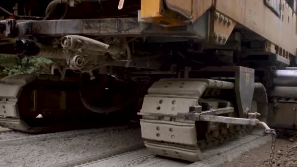 Machine with caterpillar wheels move though the road. Asphalt — Stock Video