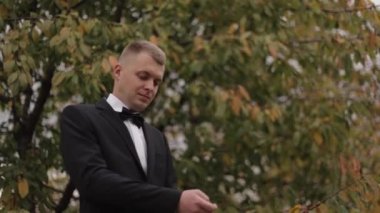 Young man in suit standing outside