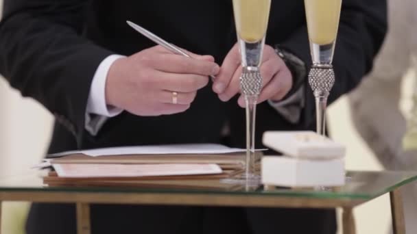 Groom and bride swear to each other for infinite love. The put signature — Stock Video