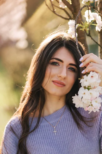 Close up of woman stand by beautiful white blooming tree