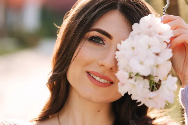 Close up of woman stand by beautiful white blooming tree