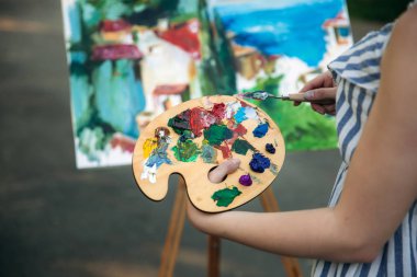 Parkta bir resim çizen güzel sarı saçlı kız geri görünümü. orta celection