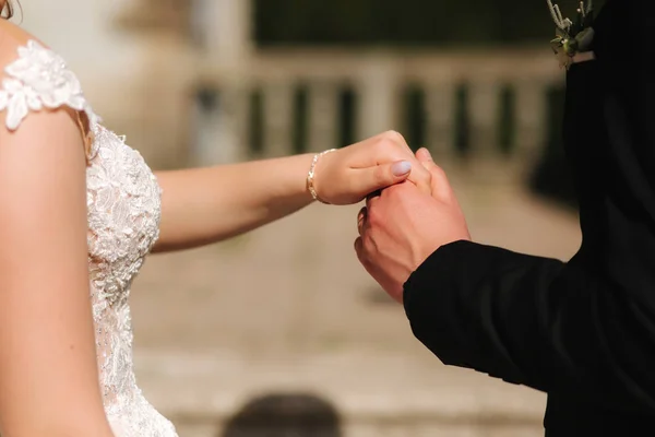 Groom hold brides hand. Gentleman. Just married couple