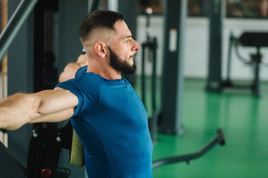 Genç bir atlet spor salonunda eğitiyor. Vücut geliştirmeci göğüs muscules trenler