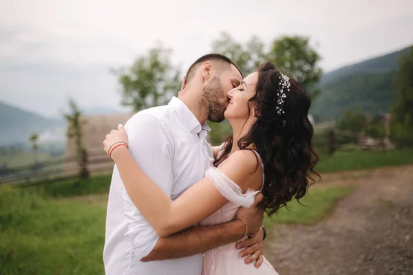 Beautiful wedding couple in Carpathian mountains. Handsome man with attractive woman. Bride spin around